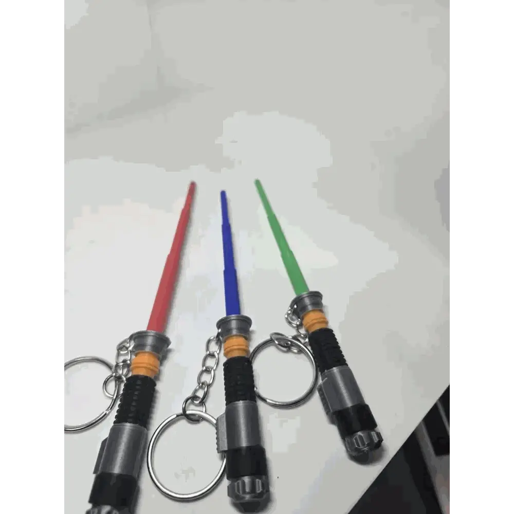 Custom 3D-printed lightsaber keychains in red, blue, and green, featuring durable design and stylish customization options.